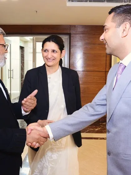 Shaking hands with colleagues at an event. Every interaction is an opportunity to listen and connect. Here, I was discussing the importance of legal aid, a cause that is very close to my heart.