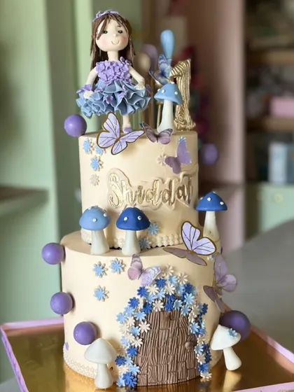 A little magic, a sprinkle of flowers, and a whole lot of love. This fairytale first birthday cake features a whimsical fairy door, delicate butterflies, and magical mushrooms.