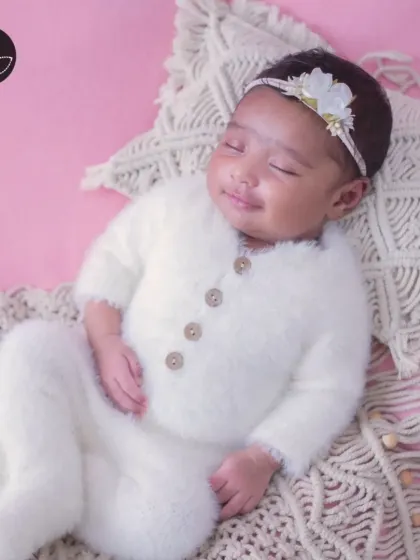 A heart-melting smile from a sleeping newborn, showcasing the pure joy and innocence of a new life.