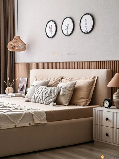 A close-up of the bedside area, showing the textured nightstand, a rustic table lamp, and the layered bedding that makes this room so inviting.