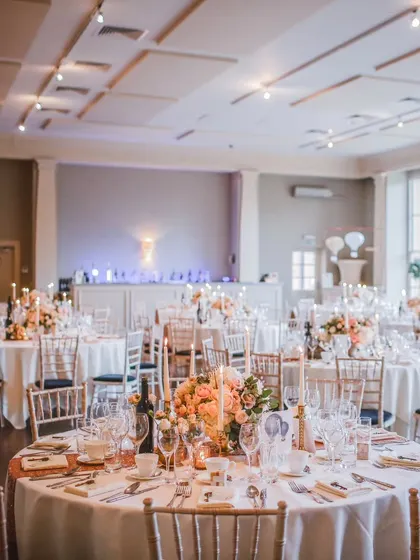 A classic round-table setup in one of our halls. The neutral tones and clean architecture of the space allow for any color palette or theme, making it a truly versatile canvas for event planners and hosts.