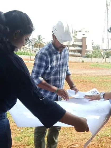 Our architects on-site, reviewing blueprints and verifying the layout for a new sports complex, ensuring that the execution aligns perfectly with the design plans.