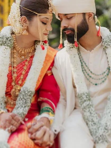 A quiet moment of connection between the bride and groom during their Marathi wedding ceremony.
