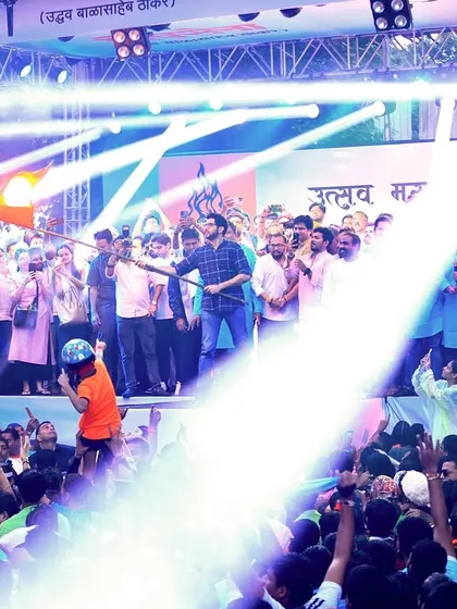 The main stage is illuminated with powerful spotlights, highlighting the dignitaries and the massive crowd at the Dahihandi Utsav. Our lighting design ensures key moments are visible to everyone.