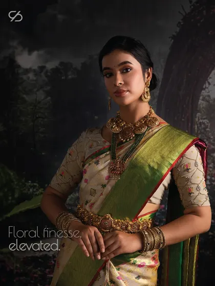 Floral finesse, elevated. This model showcases a beautiful silk saree with delicate floral prints, paired with a custom embroidered blouse for an ethereal look.