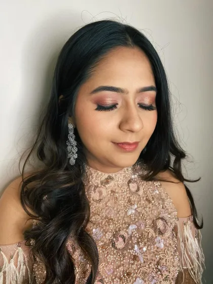 A soft and subtle engagement look. The focus is on the rosy-toned eyeshadow and flawless skin, creating a romantic and modern bridal style.