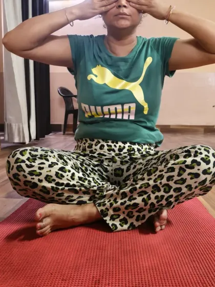 A student sits in a comfortable cross-legged position for her pranayama practice. Finding a stable and comfortable posture is the first step to any successful breathing or meditation exercise.