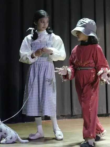 Dorothy and the Scarecrow in a scene from 'The Wizard of Oz'. This highlights character interaction and the use of props to enhance storytelling.