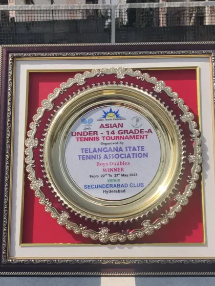 This plaque represents a significant victory. It's the winner's trophy from the Asian Under-14 Grade A Tournament in Hyderabad, won by our trainee Om Verma in the doubles event.