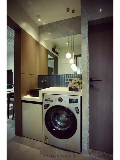 A different angle of the utility passage, highlighting the hanging pendant lights and matte-black washbasin that elevate this functional corner.