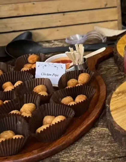 Our Chicken Pops are a hit with guests of all ages. These bite-sized chicken snacks are served in individual paper cups with a dipping sauce, making them perfect for kids' parties.