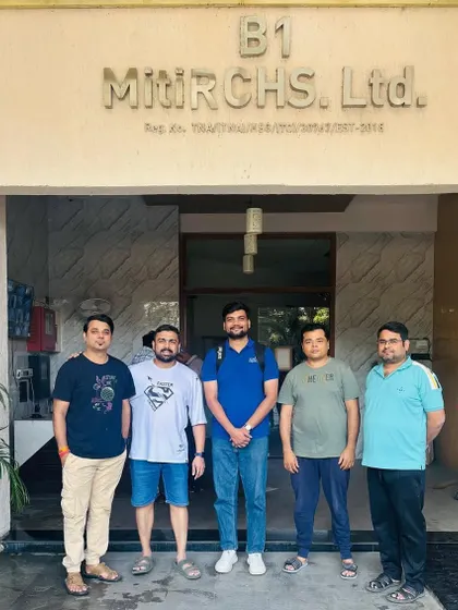 Our team stands with the committee members in front of the Miti RCHS Ltd. society building, another community joining the solar movement.