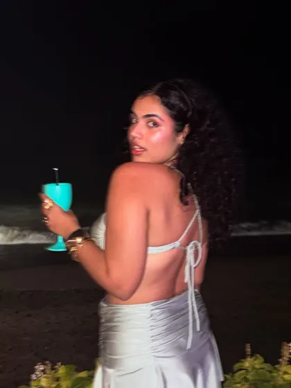 A glance over the shoulder at the beach club. The back of this metallic co-ord has a simple tie detail, adding a delicate touch to the party-ready outfit.