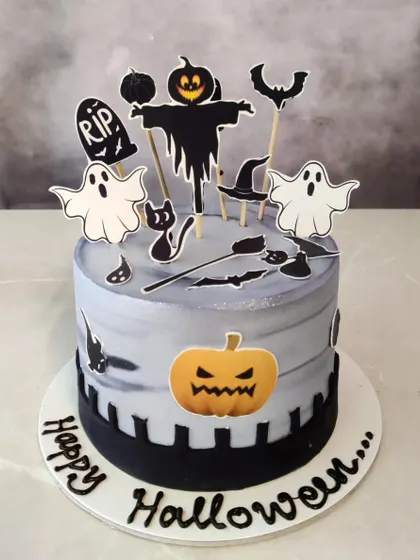 A spooky and delicious cake for Halloween! This cake features a graveyard scene with ghosts, bats, and a scarecrow, perfect for a Halloween party.
