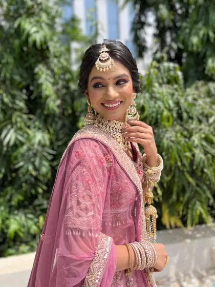 The bride's joyful smile says it all. The makeup is light and airy, perfect for celebrating in the sun.