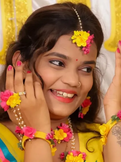A radiant bride-to-be enjoying her floral jewelry during a pre-wedding ceremony. We focus on capturing the details that make each event unique and personal.