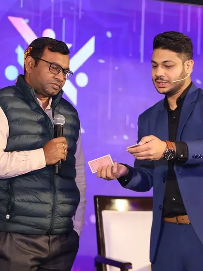 Explaining the setup for a card trick to a volunteer on stage. Even when the trick seems simple, the conclusion is always something nobody sees coming.