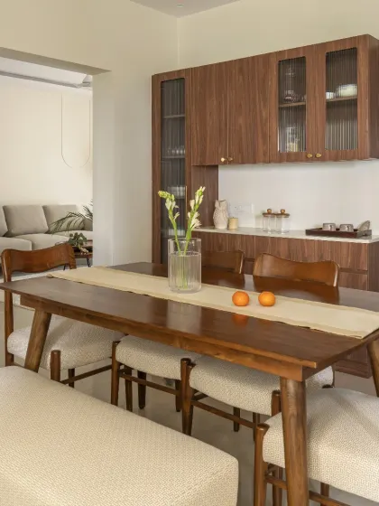 This classic wooden crockery unit features a mix of solid and fluted glass shutters, highlighted with sophisticated gold knobs. It provides ample storage while serving as an elegant piece of furniture.