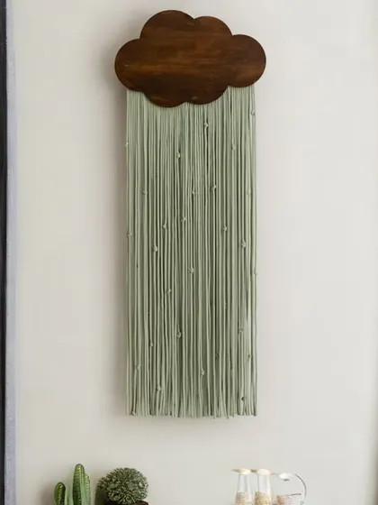 Introduce a touch of serene charm with our cloud-shaped macrame tapestry. Pictured here in a calming sage green with a dark wood finish, this piece adds a soft, dreamy element, making it a perfect wall sculpture for a bedroom, living area, or nursery.