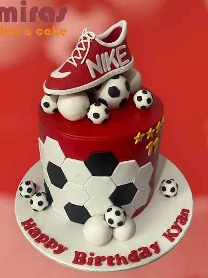 Just do it! This cake celebrates a love for sports and style with a Nike shoe theme. The design features a red shoe topper and a football-patterned tier.