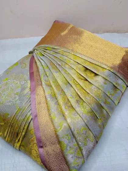 This muted green and gold saree is perfect for an elegant evening. The pleats are set and the saree is box folded, ready for you to wear.