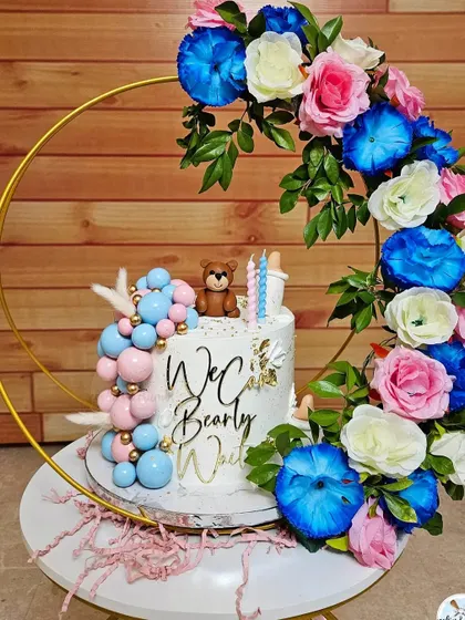 "We can bearly wait" is such a popular baby shower theme. This design features a cascade of pink and blue chocolate spheres, a fondant teddy, and milk bottles.