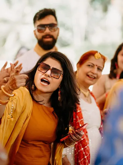 A guest enjoying the music and dancing at the Haldi ceremony, captured in a candid moment.