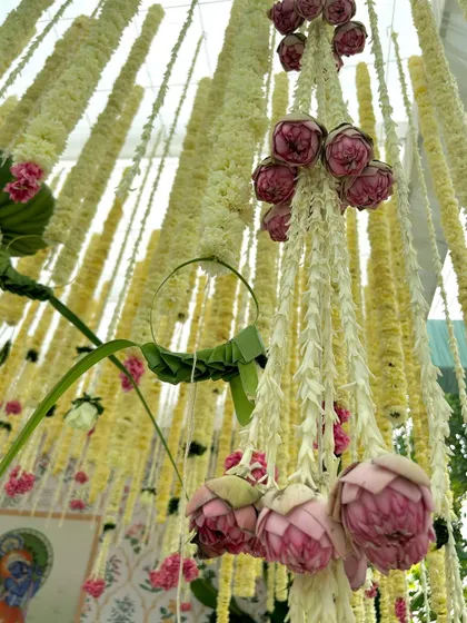 A close-up of the delicate floral hangings, featuring jasmine and lotus buds, a signature element of our traditional South Indian decor.