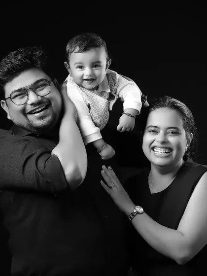 A moment of pure family joy, captured in a timeless black and white studio portrait. The genuine laughter and interaction make this a perfect example of the happy, candid moments we love to freeze in time.