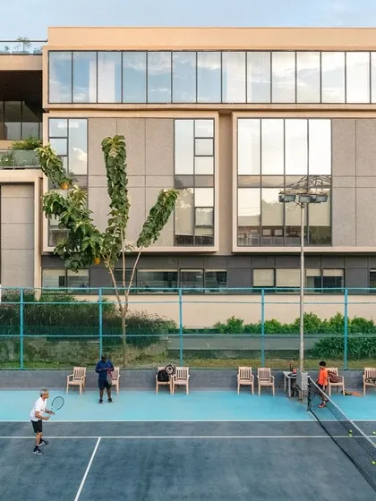 The annexe for the Koramangala Club in Bangalore was designed to seamlessly integrate with the existing campus. This view of the tennis courts against the new building highlights our ability to design large-scale recreational spaces that are both functional and contextually sensitive, enhancing community life.