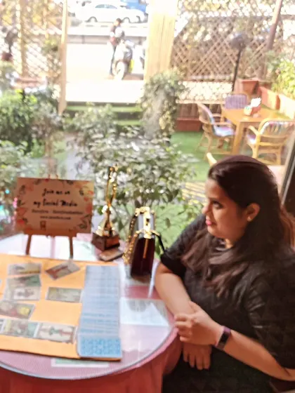 A tarot reading in progress at a pop-up event. My focus is always on the client, creating a one-on-one connection to explore their unique journey.