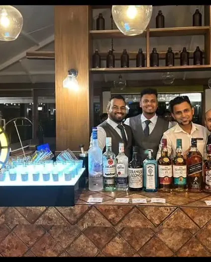 Our team ready for service at a rustic-themed bar. We are adaptable and professional, no matter the style or location of the event.