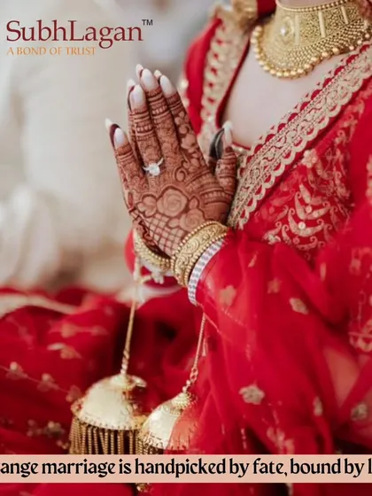 A bride's hands in a prayer position, showing her choora and kalire. We believe an arranged marriage is handpicked by fate and bound by love.