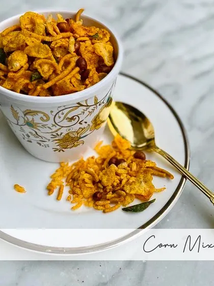 My Corn Mixture is made with corn flakes, peanuts, besan, curry leaves, and red chillies. It's a simple, crunchy, and satisfying snack.