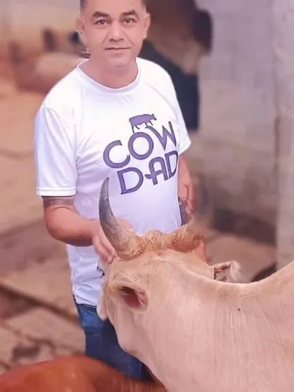 A portrait with one of my cows. The 'Cow Dad' shirt says it all.