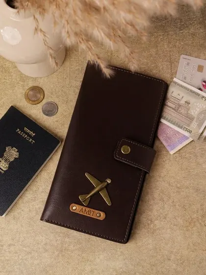This personalized travel wallet is a must-have for any globetrotter. Made from dark brown vegan leather, it has space for a passport, cards, and cash, and is customized with a name and an airplane charm.