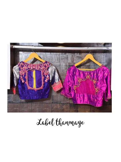 A pair of heavily embroidered blouses. The purple one has silver sleeves and the pink one is made of rich raw silk.
