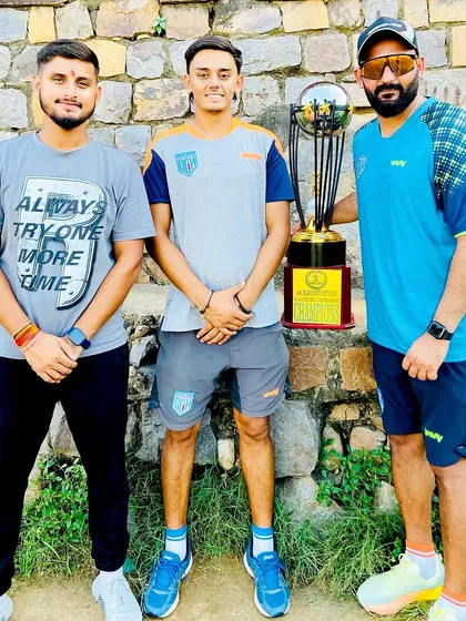 Another angle of the coaching team with the trophy. We lead by example.