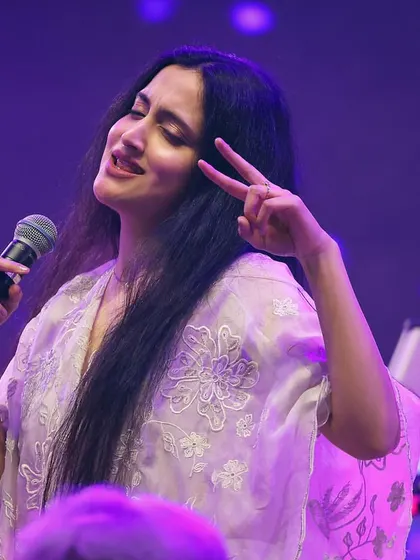 Flashing a peace sign to the audience during a fun Garba performance. It's all about spreading good vibes and celebrating music together.