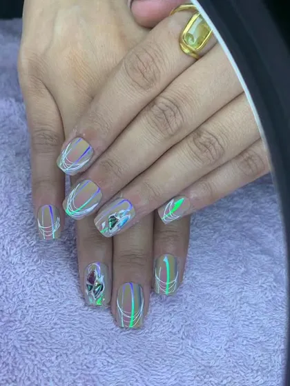 A unique design with a nude base, rainbow chrome lines, and a 3D rose accent.
