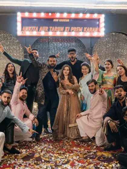 The whole gang! The couple and their friends celebrate on the sangeet stage, showered in confetti.