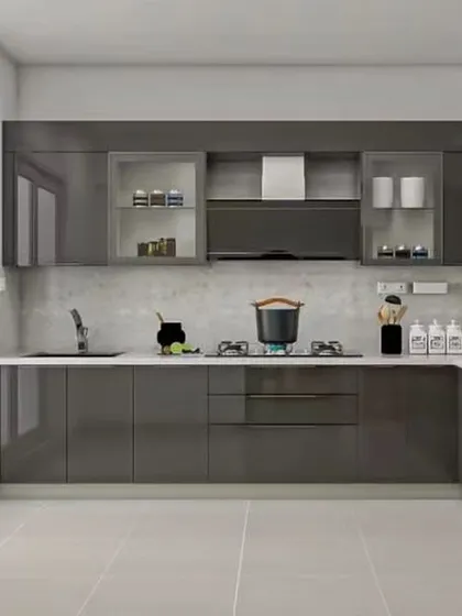 This glossy grey L-shaped kitchen is both stylish and practical, with frosted glass cabinets and built-in appliances.