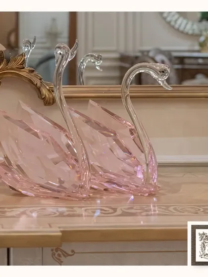 Grace and elegance are captured in these exquisite pink crystal swan sculptures. They bring a touch of refined beauty and delicate color to a vanity or console table.