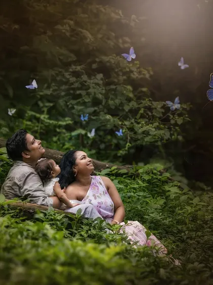 A family immersed in the beauty of the forest, looking up as magical butterflies flutter by. This fine art portrait blends reality with a touch of enchantment.