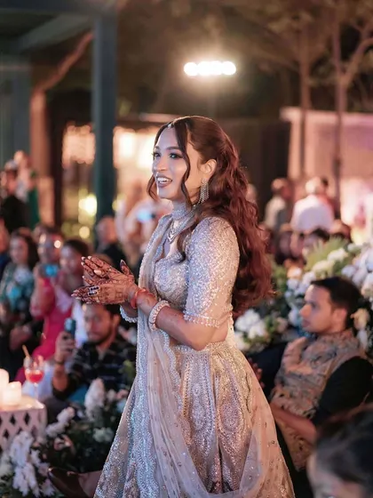 A beautiful, happy candid from the sangeet ceremony. Her smile and radiant makeup light up the frame.