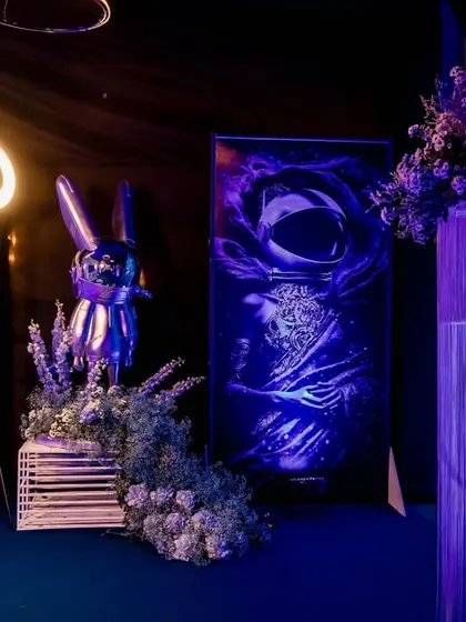 A creative photo booth or selfie station with a space theme, featuring astronaut art and a ring light for perfect pictures.