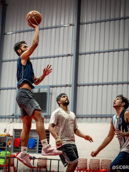 A skilled player finishing strong at the rim, demonstrating the athleticism we cultivate at the academy.