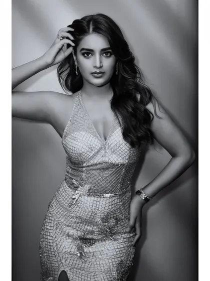 A timeless black and white portrait of Nidhhi Agerwal. This version of her glamour shot emphasizes form, expression, and the texture of her sequined dress.