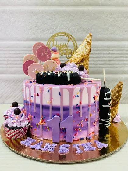 A still shot of the impressive ice cream themed cake, complete with cakesicles and cones.