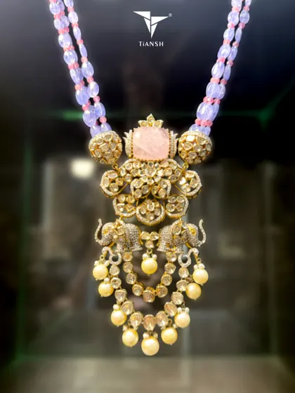 Handcrafted in gold, with polki that catches light like morning dew, and elephants that stand as guardians of grace. This necklace is not just worn, it is remembered.
